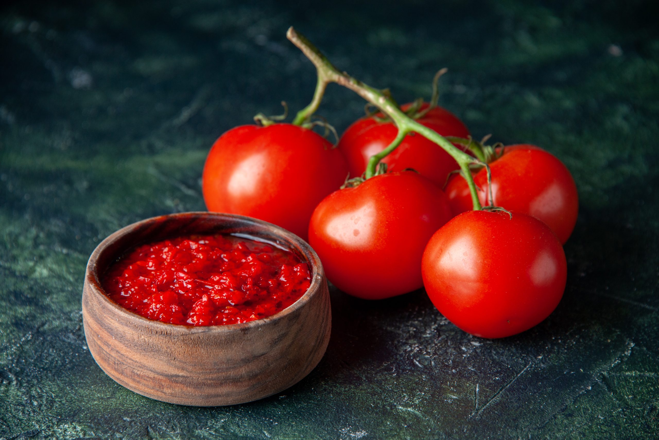 front-view-tomato-sauce-with-fresh-red-tomatoes-dark-surface-tomato-red-color-seasoning-pepper-salt